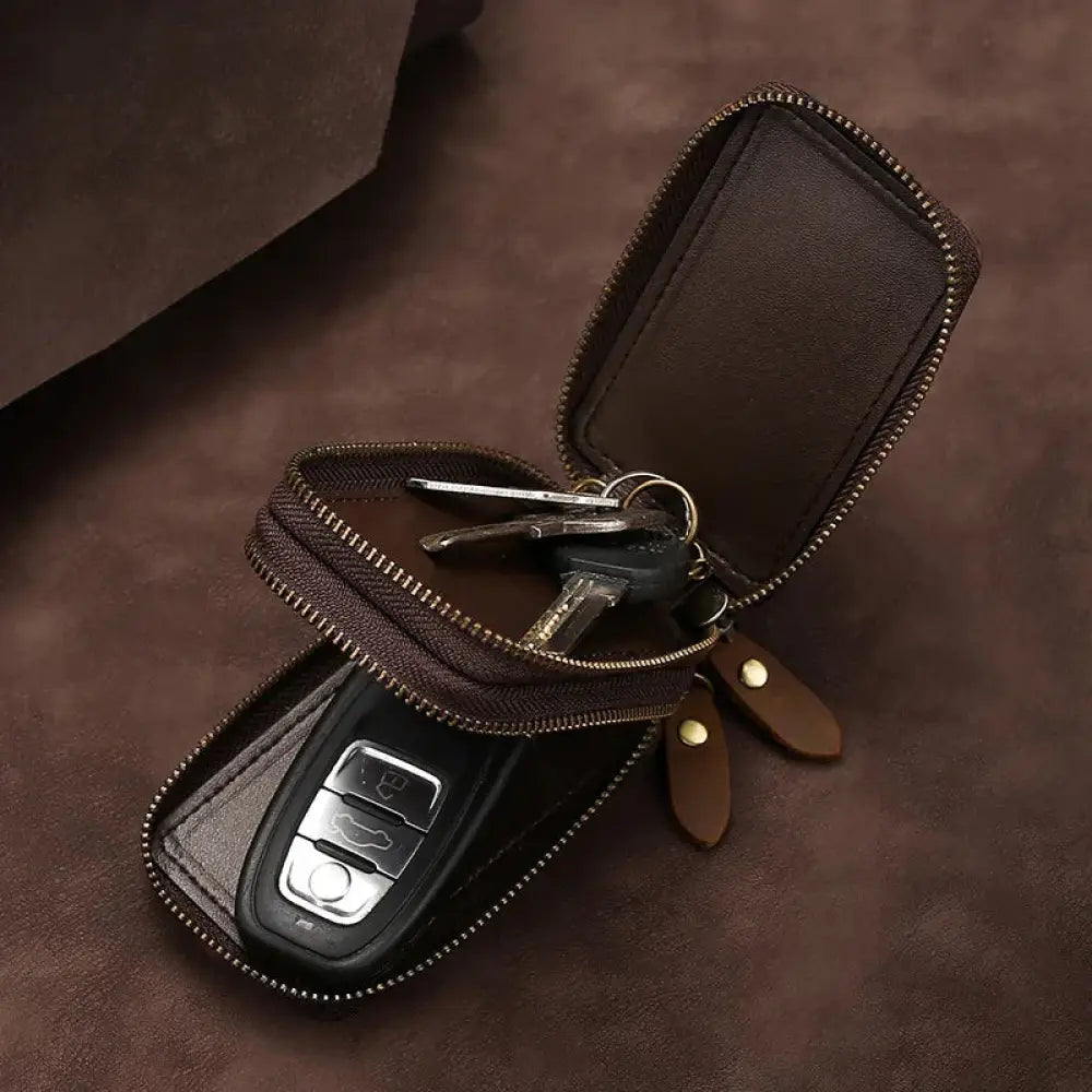 Brown crazy horse leather key case with zipper closure and matching leather tabs featuring brass clasp