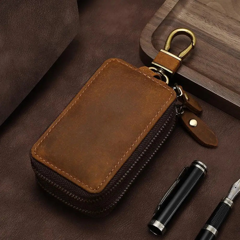 Premium crazy horse leather zip key case in brown with brass-colored metal clasp and zipper for secure storage