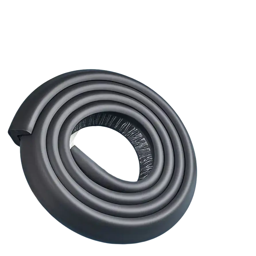 Black foam safety corner protector guard coiled beside a plush teddy bear for table edge cushioning