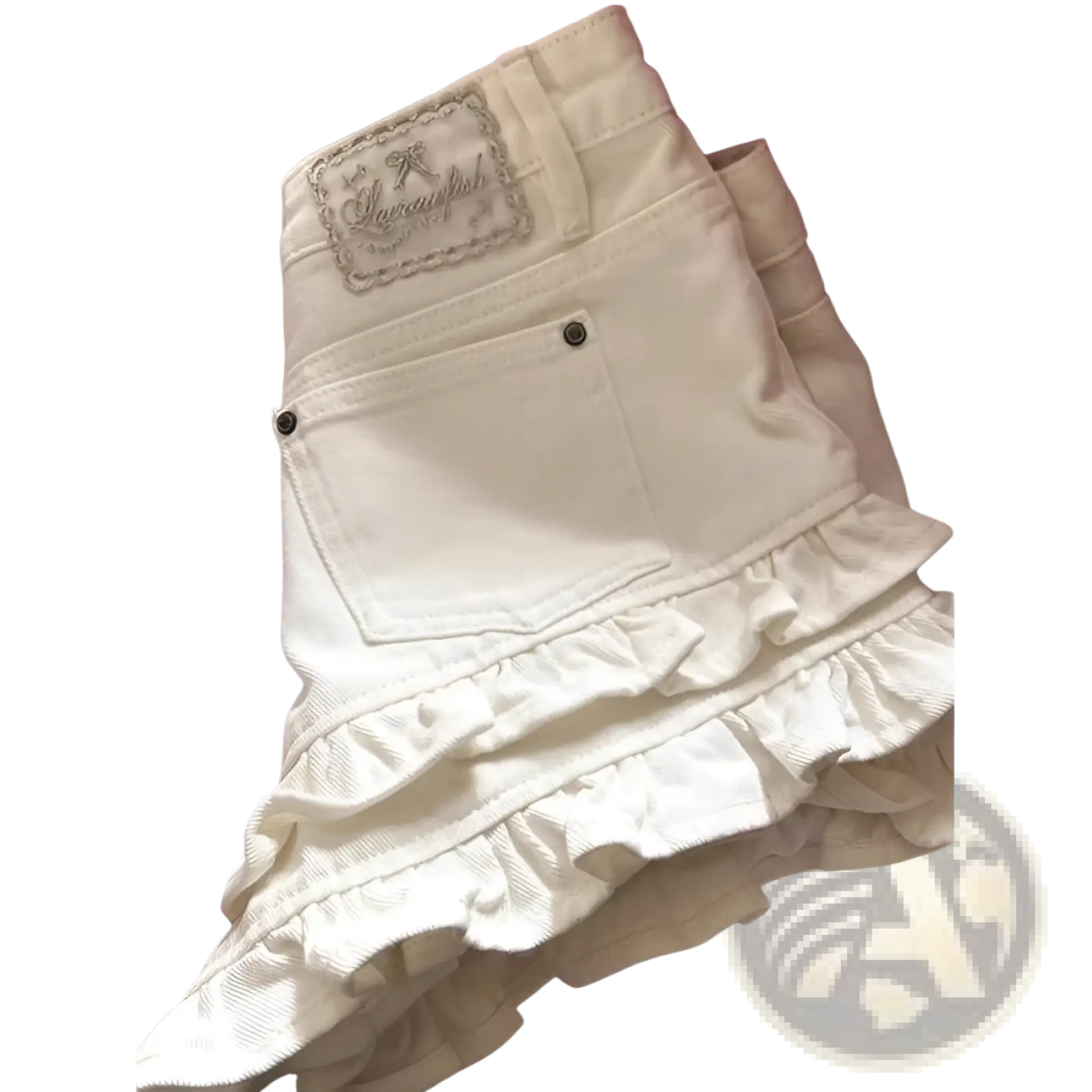 Back side of cream ruffled denim shorts high waist featuring layered ruffles and an embroidered patch on waistband