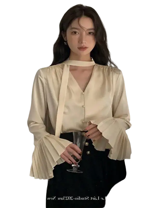 Cream satin blouse with long flared pleated sleeves and high neckline for elegant formal wear