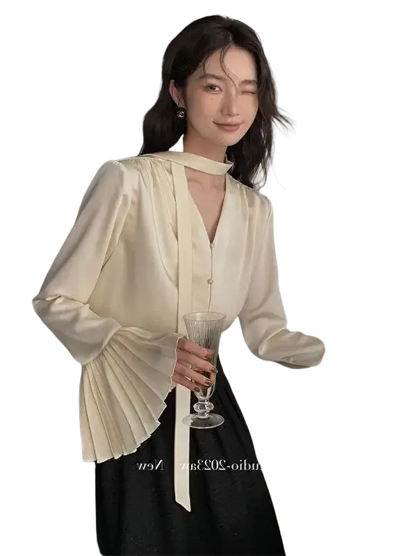 Cream satin blouse with long sleeves and pleated cuffs made of smooth satin fabric for elegant wear