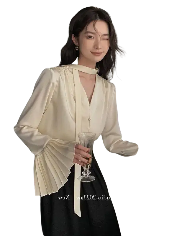 Cream satin blouse with long sleeves and pleated cuffs in a smooth satin fabric for elegant wear