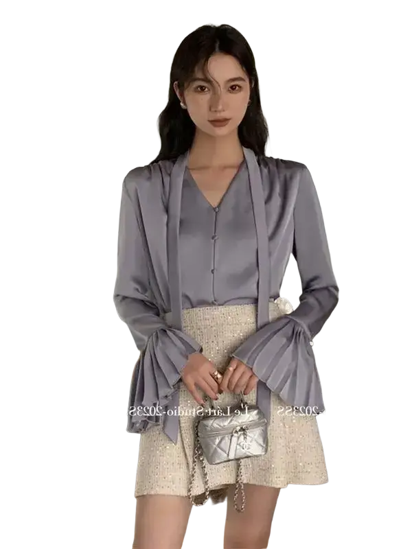 Silver quilted chain strap handbag paired with a cream satin blouse long sleeve pleated top for elegant wear