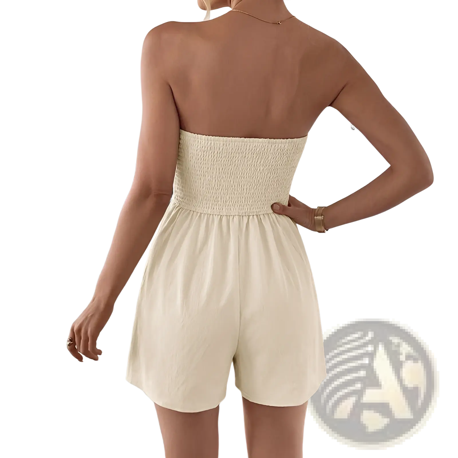 Cream strapless pleated jumpsuit featuring a cream-colored smocked romper with gathered waistband and loose shorts