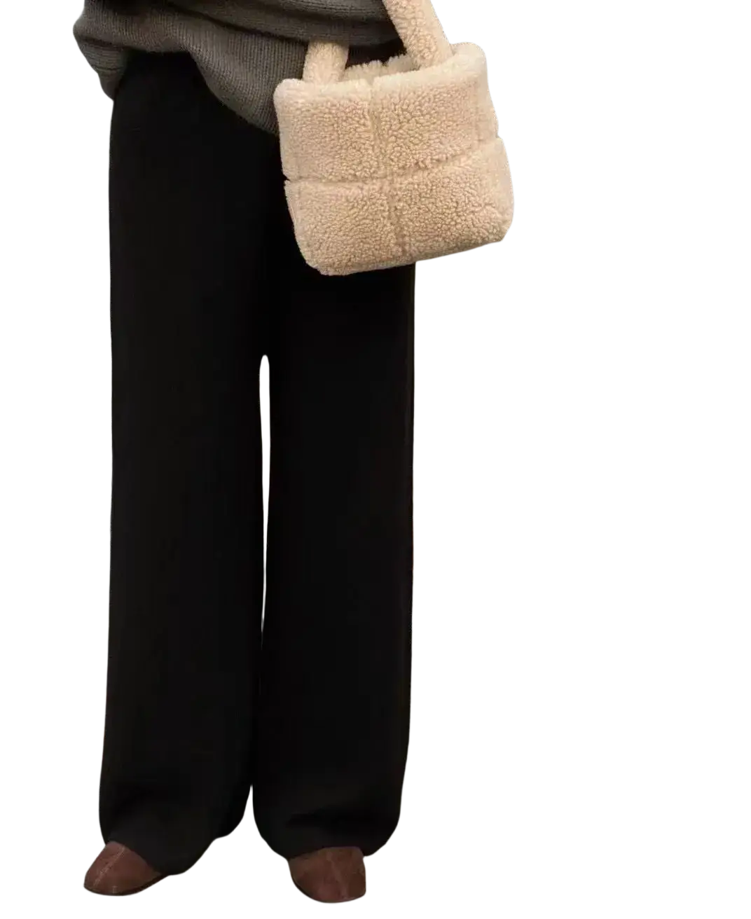 Cream wool wide leg knit pants paired with a cream-colored plush shearling quilted handbag with soft handles