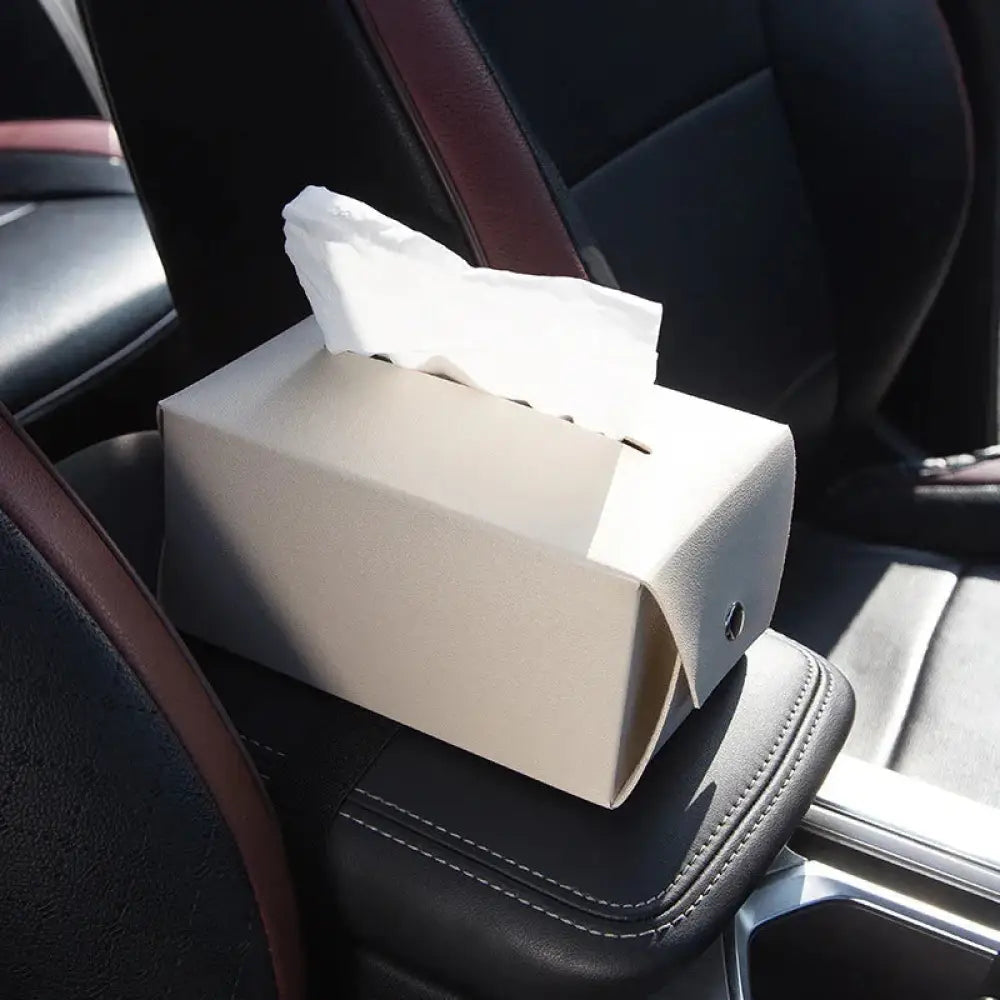 Beige textured premium cartoon leather car headrest tissue box with a single white tissue partially pulled out