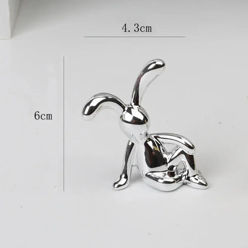 Shiny silver metallic minimalist rabbit figurine with smooth curves and reflective surface for home decor