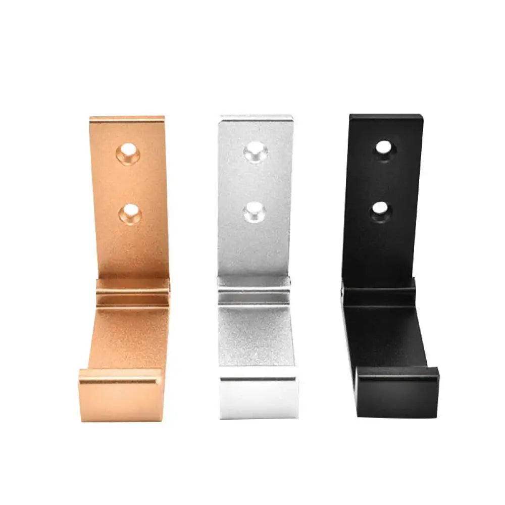 Three foldable aluminum alloy minimalist wall hooks in rose gold silver and black finishes displayed on a wall