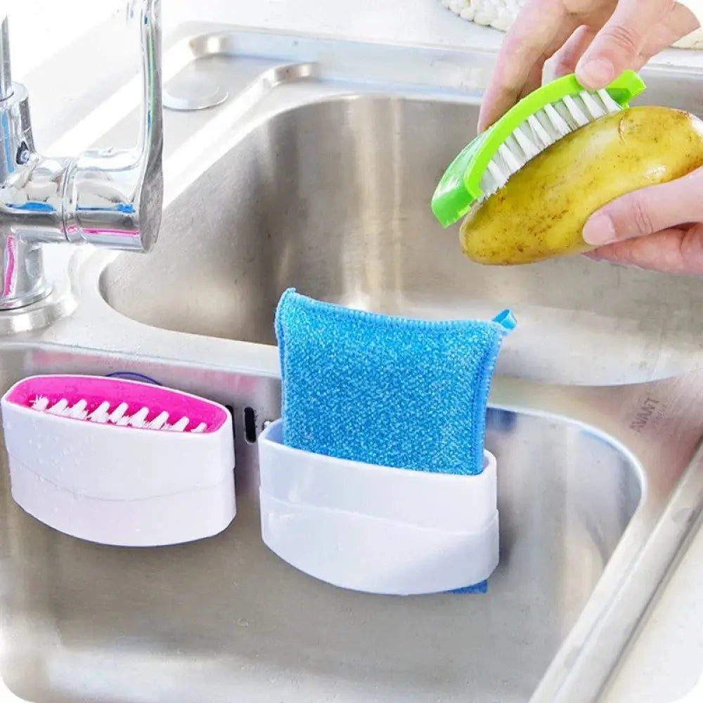 Multiuse suction cup kitchen brush and utensil scrubber in green and white with bristles cleaning a potato