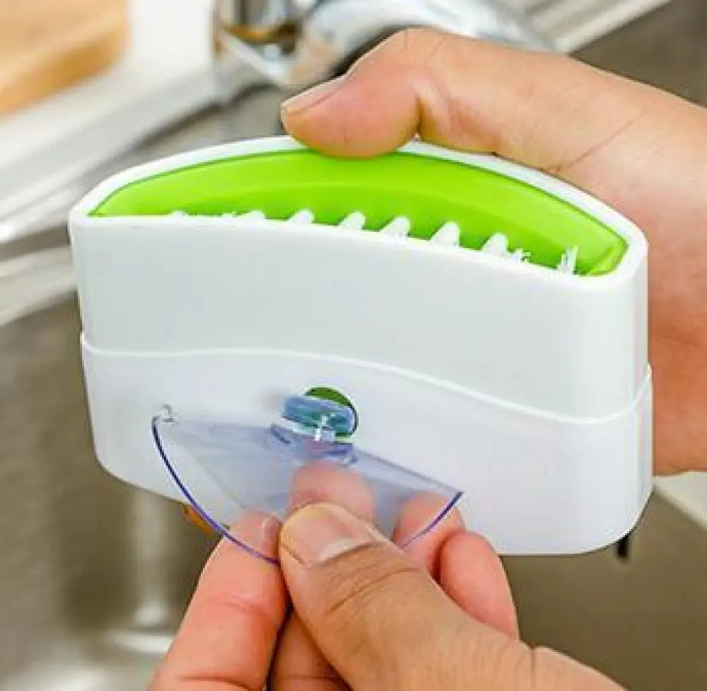 White and lime green plastic multiuse suction cup kitchen brush and utensil scrubber for versatile cleaning tasks