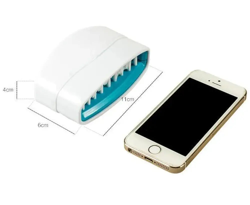 White and teal plastic multiuse suction cup kitchen brush and utensil scrubber with curved ergonomic design