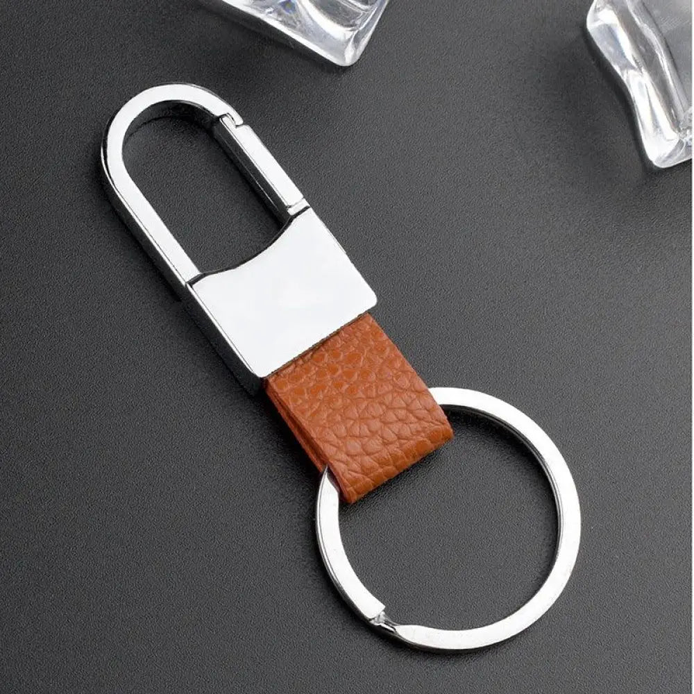 Premium leather and metal carabiner car keychain with brown textured leather strap and silver-toned metal attachments