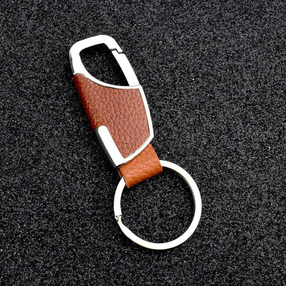 Premium leather and metal carabiner car keychain in brown leather with silver-toned metal clip for secure attachment