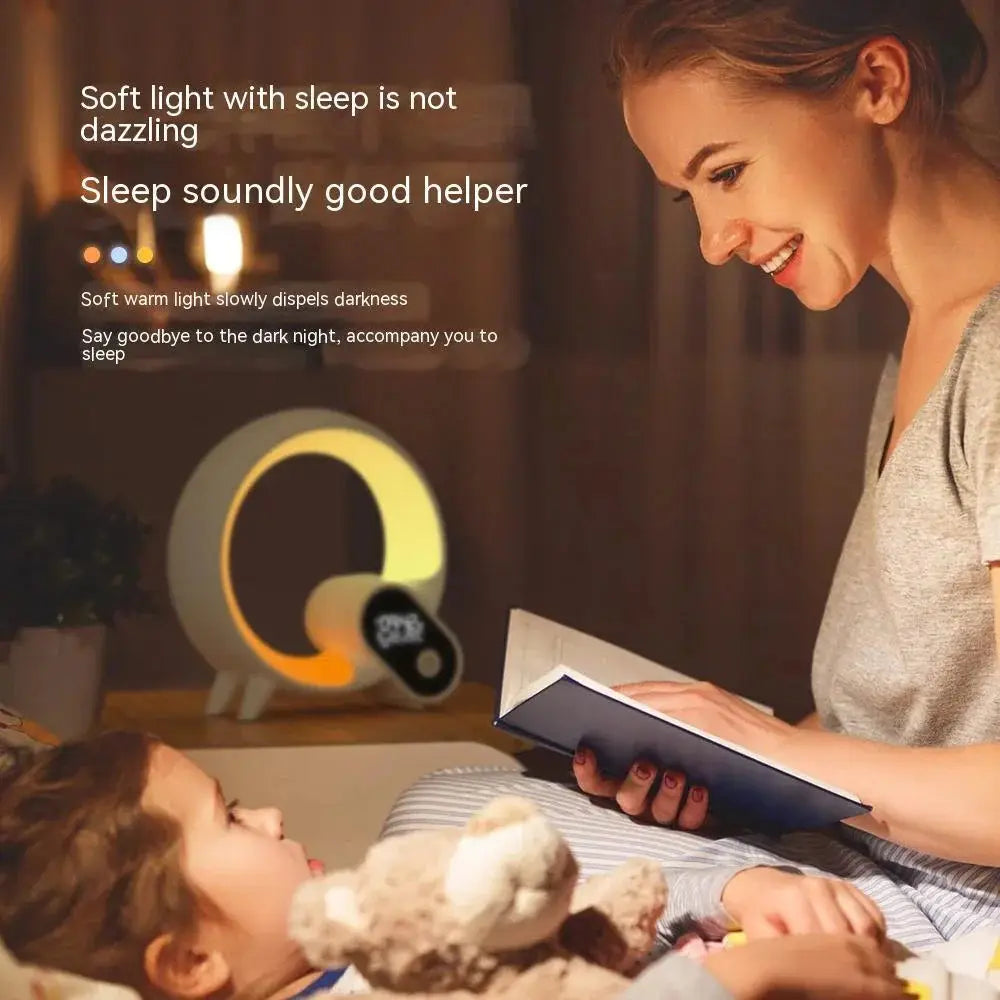 Q-light sunrise alarm clock with bluetooth speaker featuring a modern white plastic body and warm yellow q-shaped nightlight