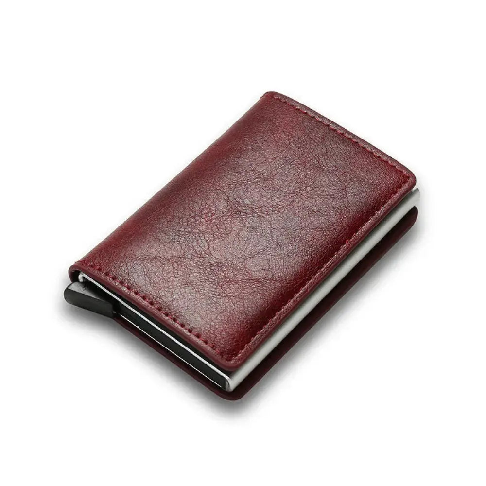 A sleek burgundy leather smart minimalist RFID carbon fiber card holder wallet with metallic silver clip and black magnetic closure