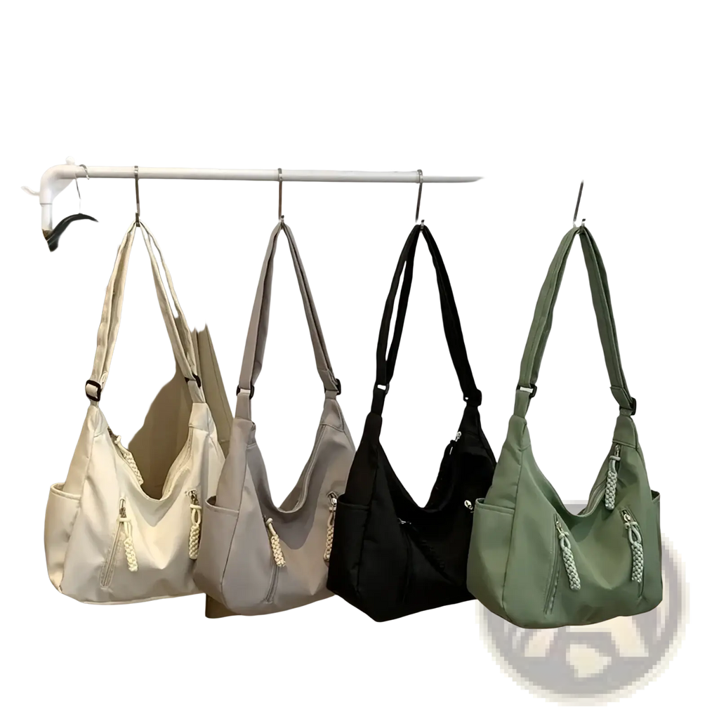 A collection of crescent nylon crossbody bags in cream gray black and olive green with braided zipper pulls