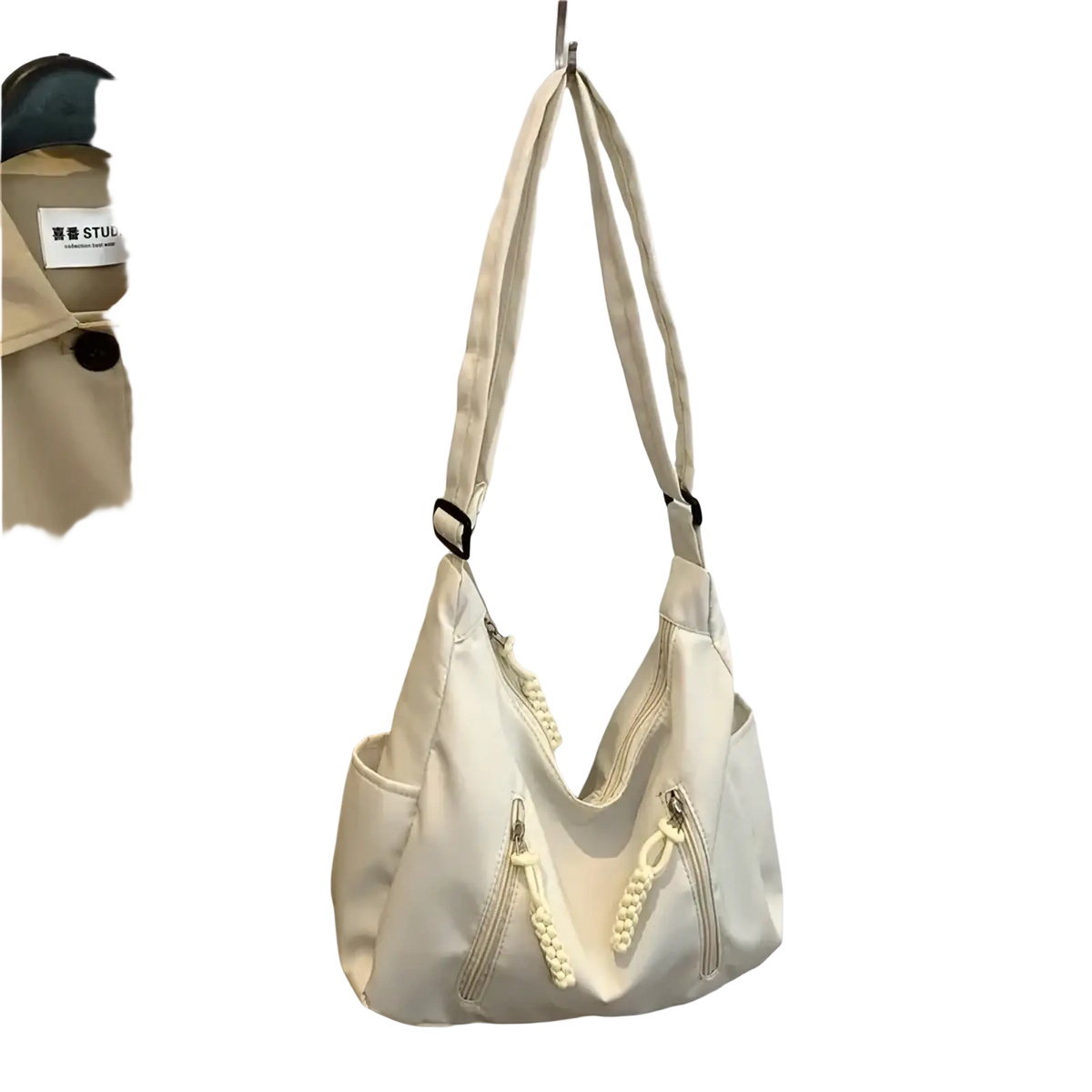 Cream-colored canvas crescent nylon crossbody bag with braided zipper pulls and black hardware accents lightweight tote