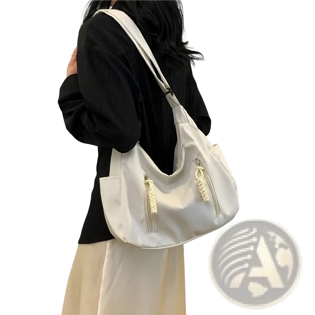 A sleek white crescent nylon crossbody bag with braided zipper pulls and minimalist lightweight shoulder tote design