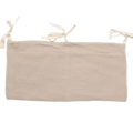 Beige linen crib storage bag diaper organizer showing tie-back with three tied fabric loops