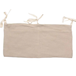 Beige linen crib storage bag diaper organizer showing tie-back with three tied fabric loops
