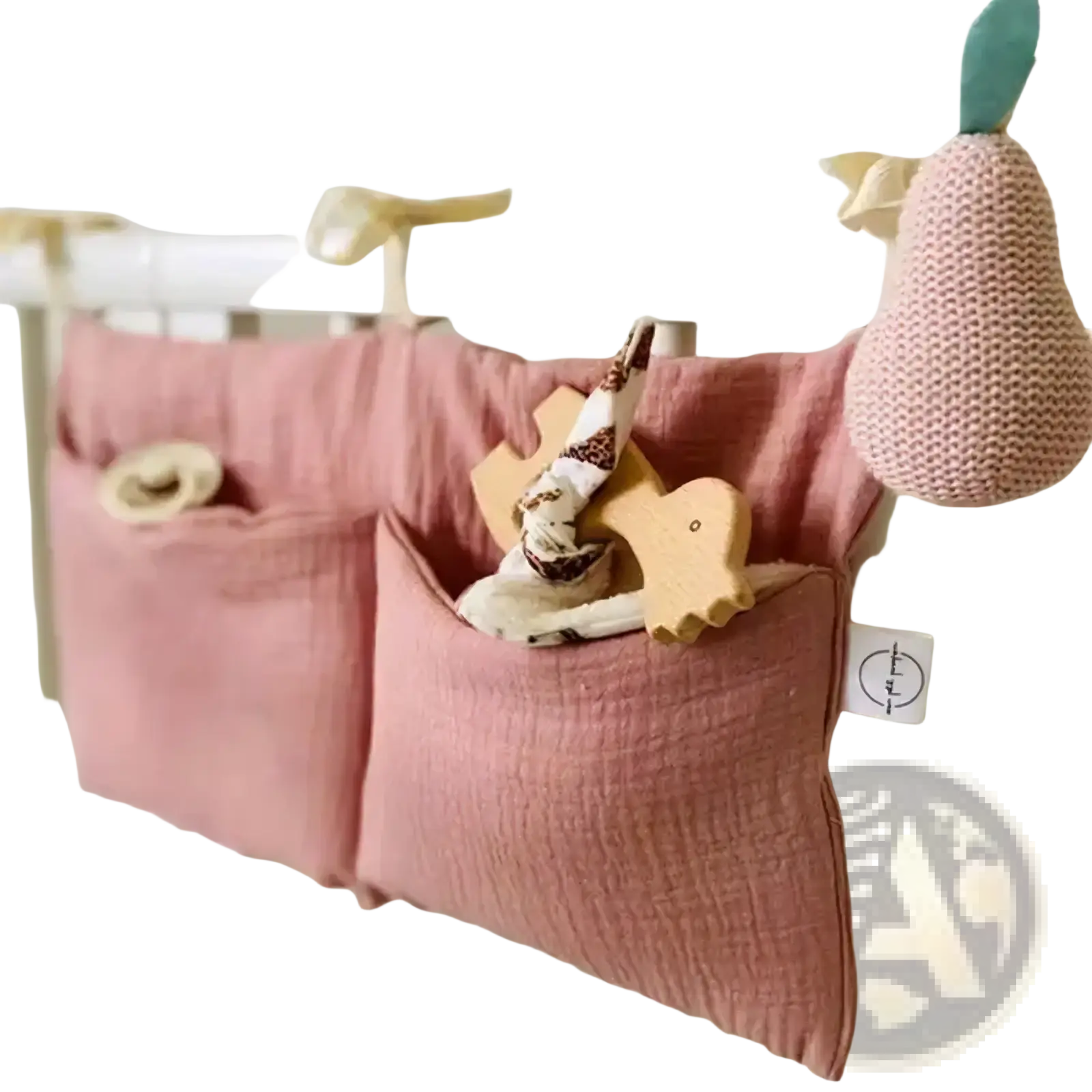 Pink cotton crib storage bag diaper organizer with two pockets hanging on crib rail for convenient storage