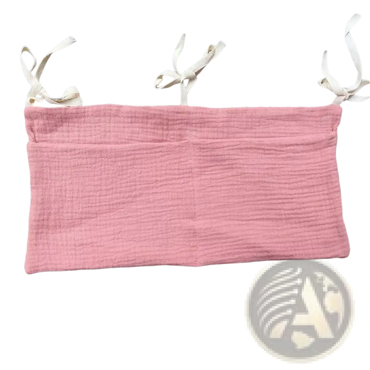 Soft pink textured cotton bandeau top with adjustable white fabric shoulder ties shown with crib storage bag diaper organizer