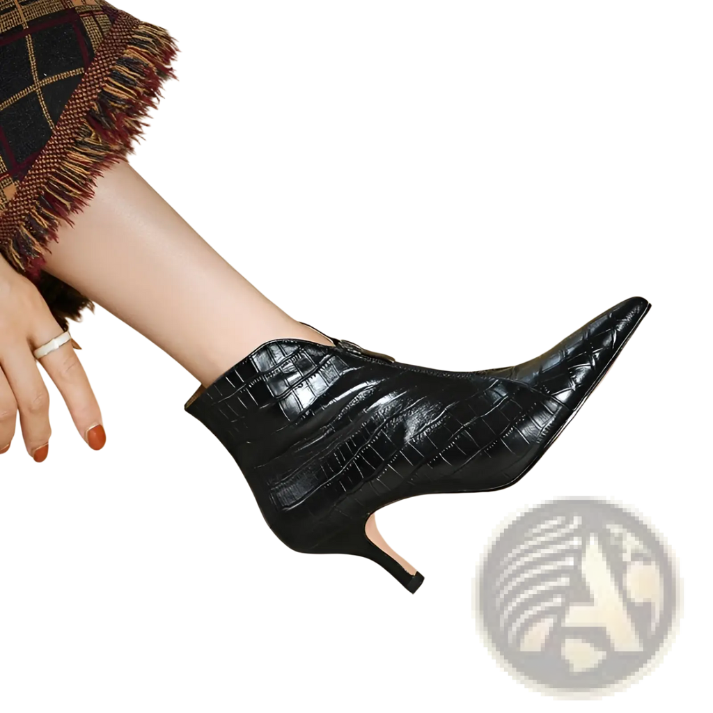 Black croc embossed leather ankle boot with a slender high heel shown from the back side