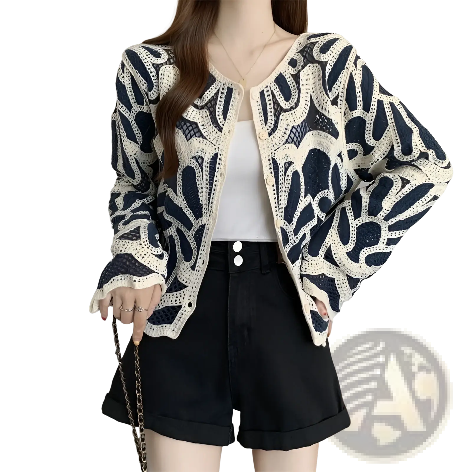 A navy blue and cream-colored crochet cardigan with intricate leaf-like floral patterns and a loose pullover design