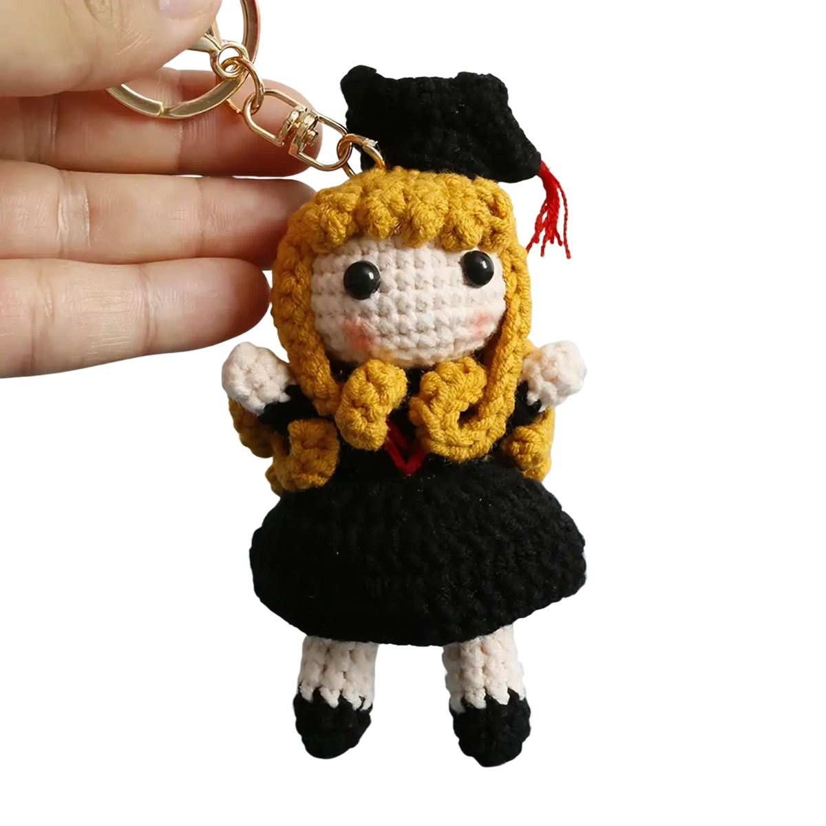 Crochet graduation doll keychain with golden yarn hair black cap and dress white socks and gold metal ring attachment