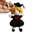 Crochet graduation doll keychain with blonde yarn hair black and white outfit red trim and black cap with red tassel