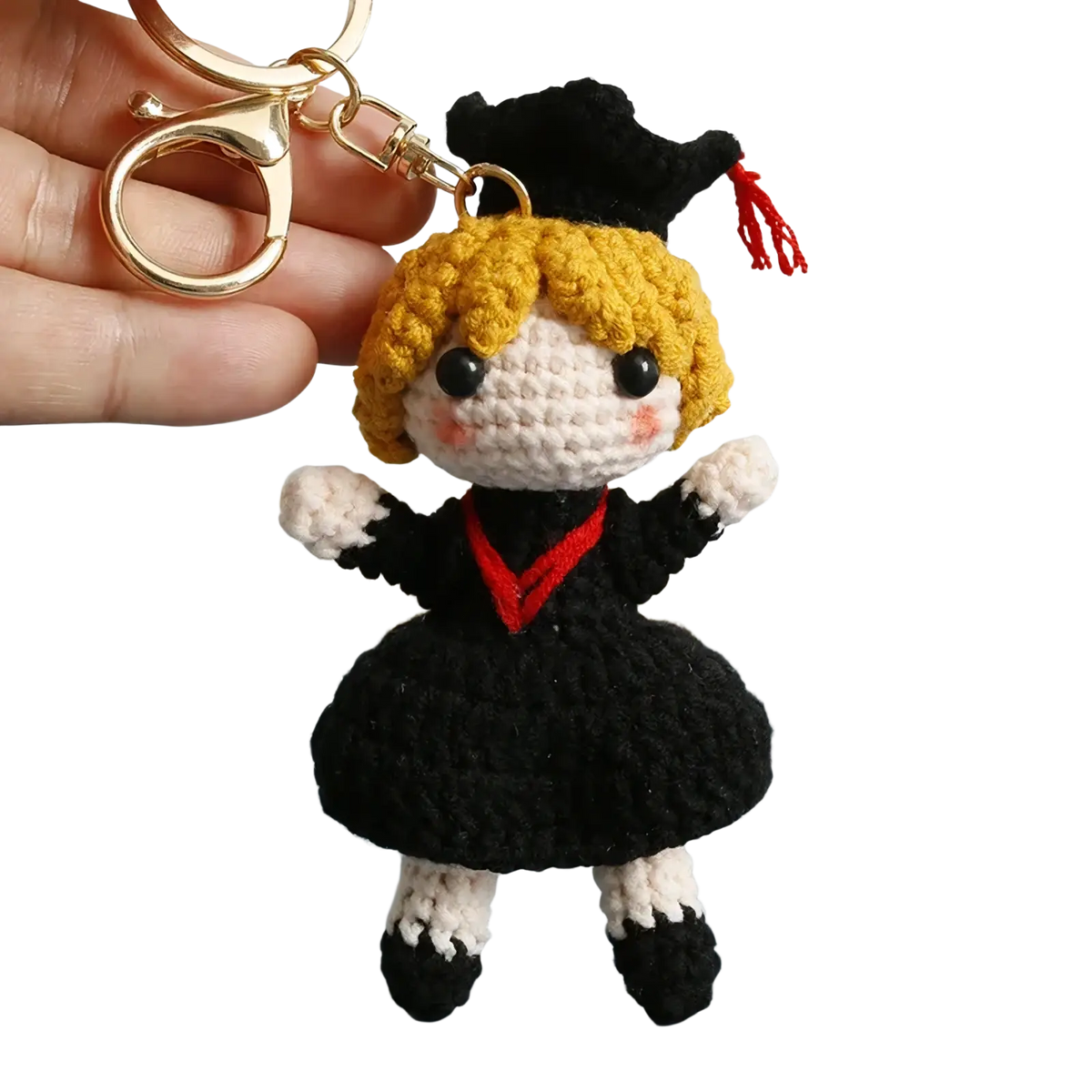 Crochet graduation doll keychain with blonde yarn hair black and white outfit red trim and black cap with red tassel