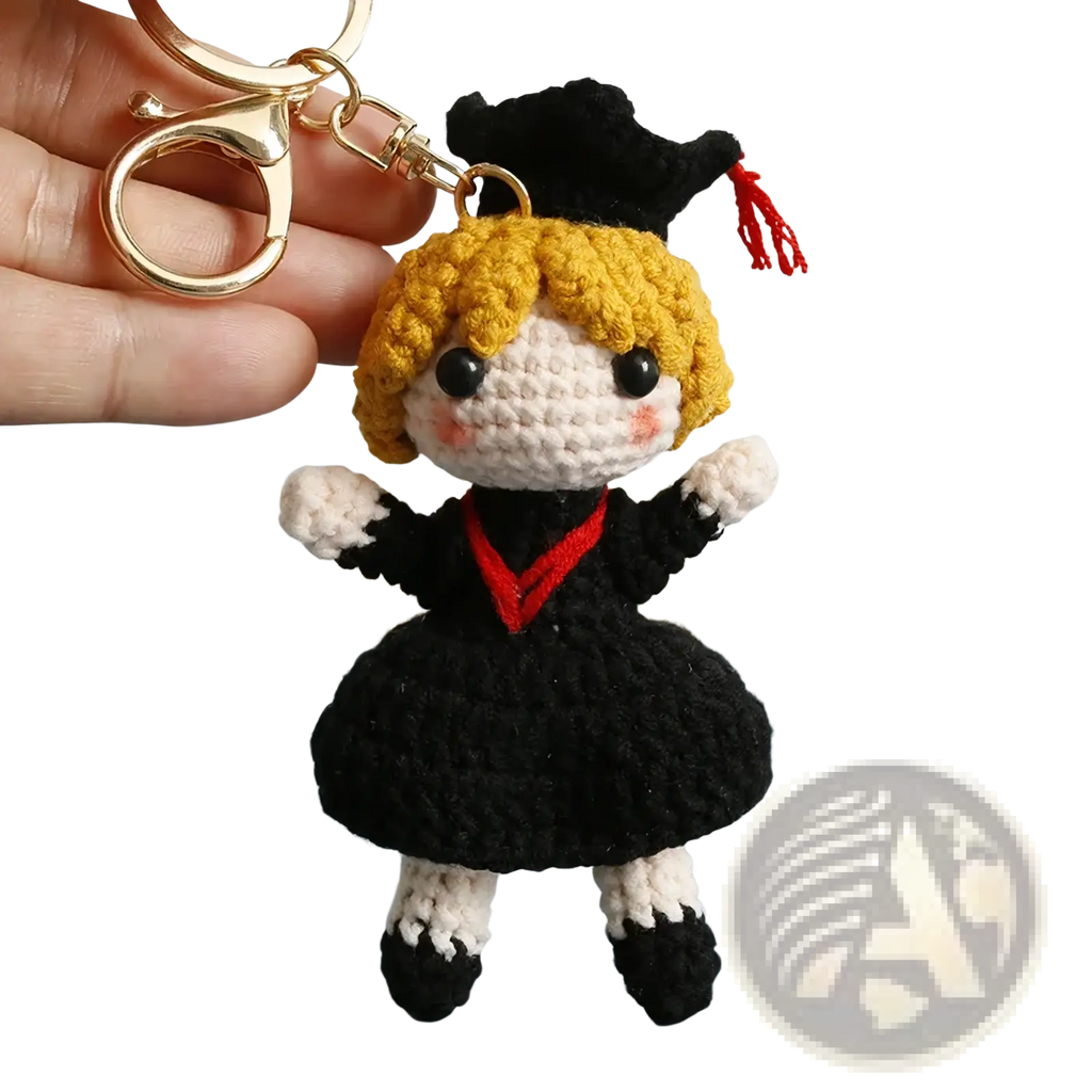 Crochet graduation doll keychain with blonde yarn hair black and white outfit red trim and black cap with red tassel
