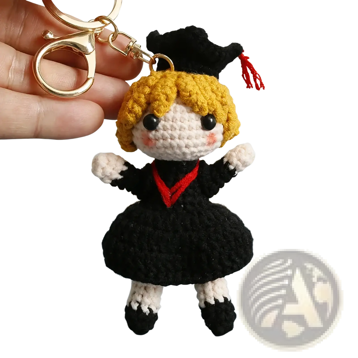 Crochet graduation doll keychain with blonde yarn hair black and white outfit red trim and black cap with red tassel