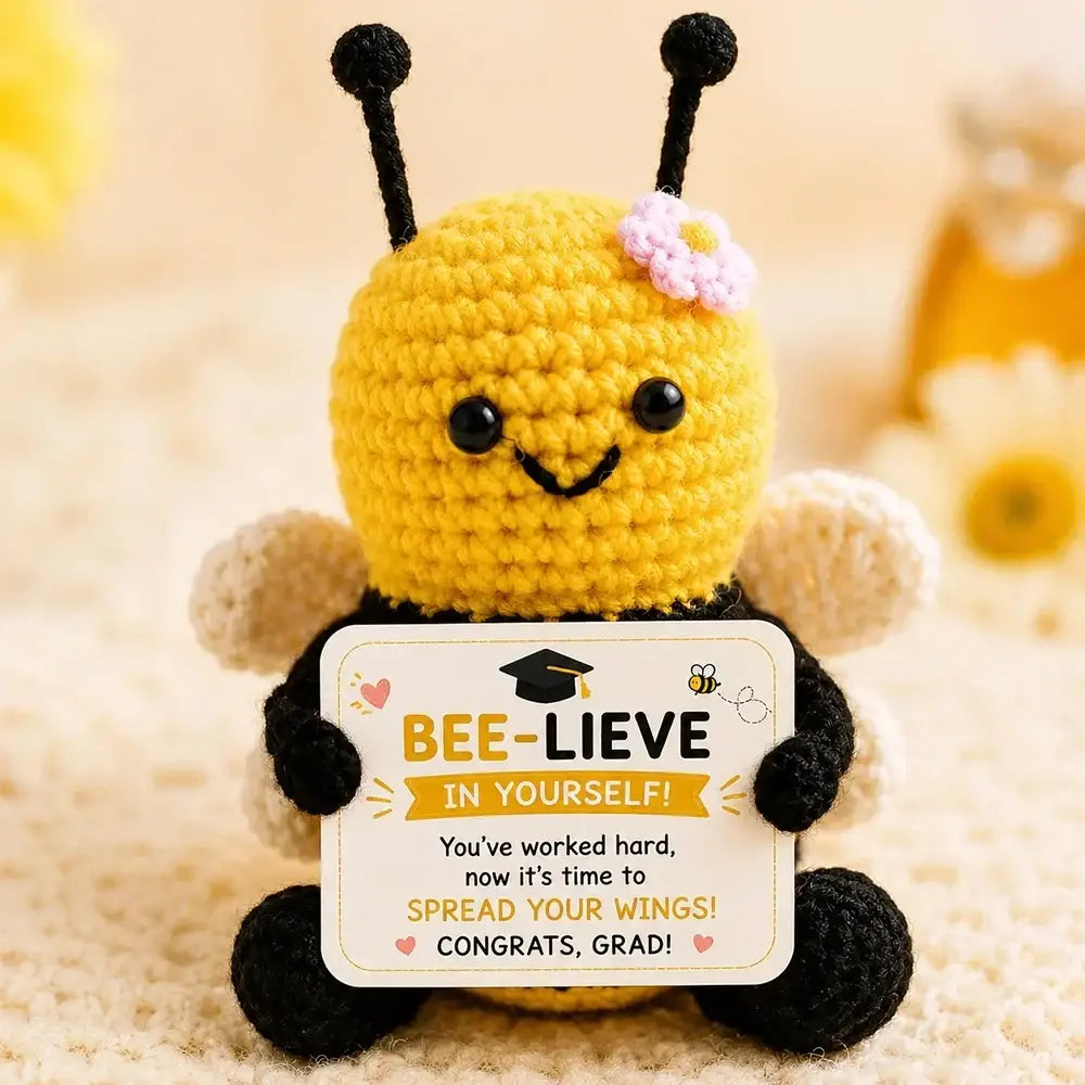 Crochet graduation puppy pocket hug keepsake featuring yellow crocheted bee with black wings holding a graduation card