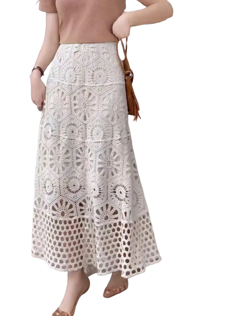 A delicate off-white crochet lace maxi skirt featuring intricate circular and hexagonal patterns perfect for summer