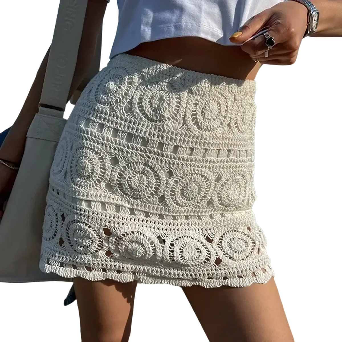Off-white crochet lace mini skirt with intricate circular patterns and fringed hem for summer wear