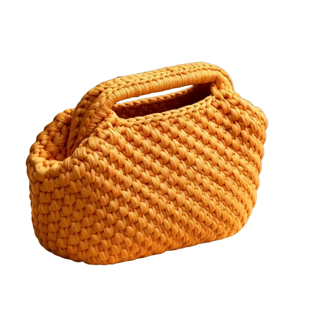 A cozy mustard-yellow crocheted shoulder bag with chunky knit pattern and integrated top handle for beach use