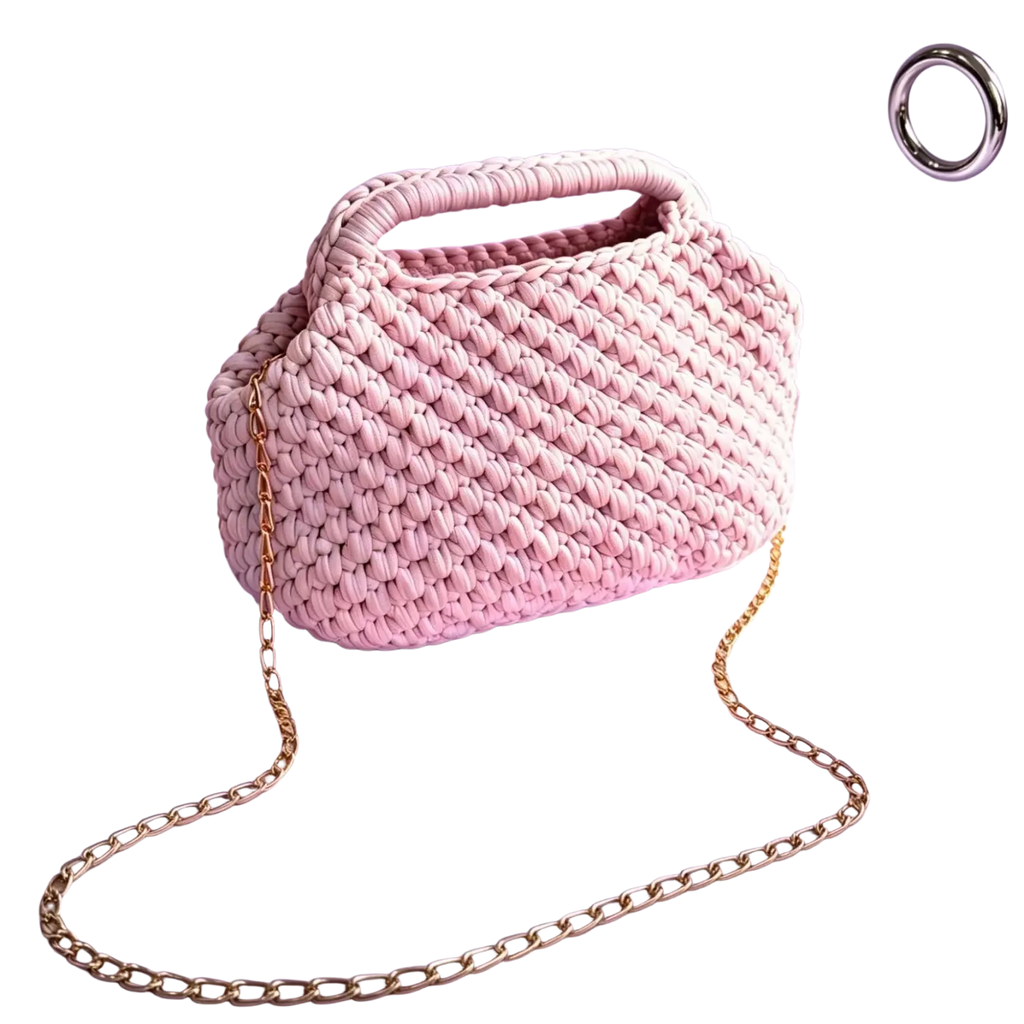A soft pink crocheted shoulder bag with a textured woven pattern and gold chain strap beach tote purse