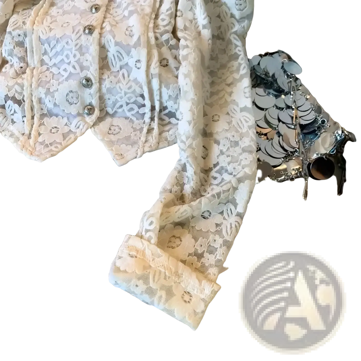 A cream-colored crocheted lace bubble sleeve blouse with floral patterns and silver button accents