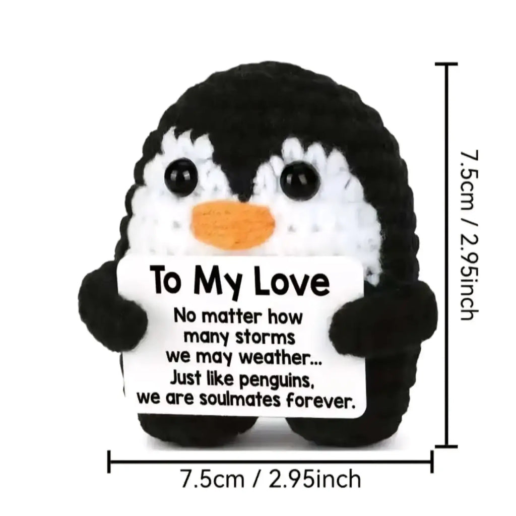 Crocheted black and white penguin plush toy with orange beak holding a to my love sign for romantic gift