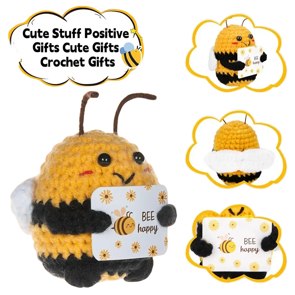 A yellow and black crocheted bee plush toy holding a bee happy card in a positive bee keychain and bag charm
