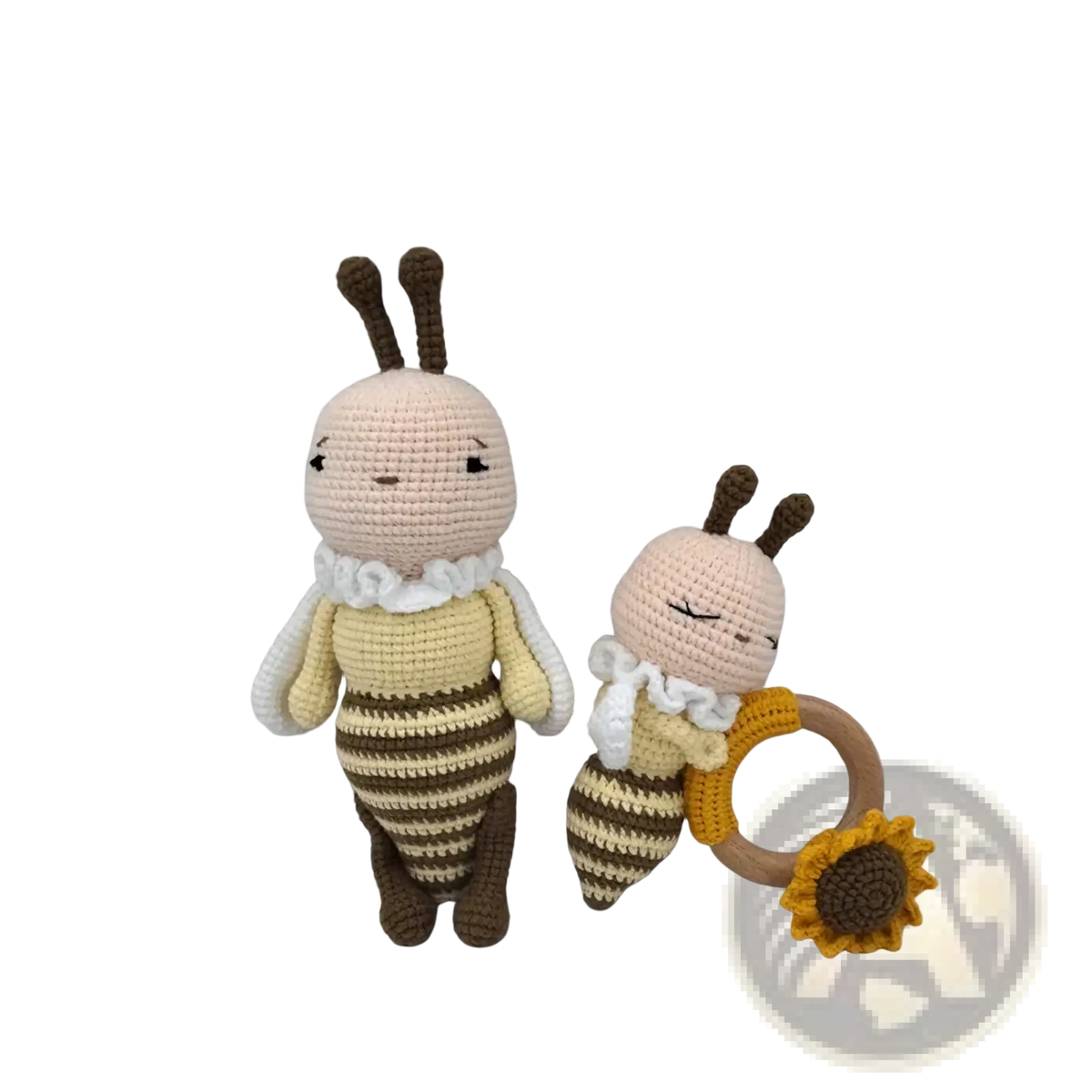 Crocheted unicorn baby comforter with cream and brown bee plush toys and wooden sunflower teething ring