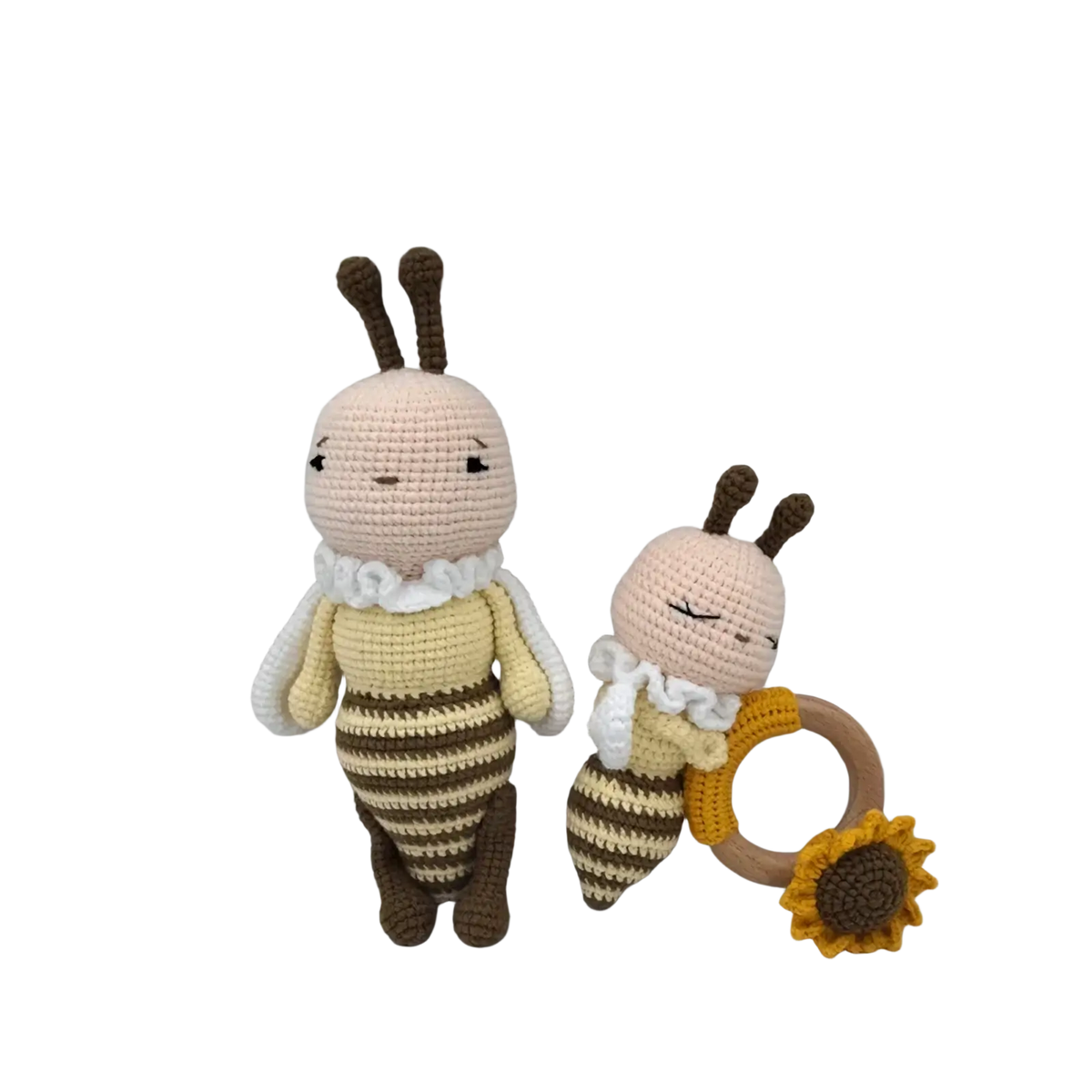 Crocheted unicorn baby comforter with cream and brown bee plush toys and wooden sunflower teething ring
