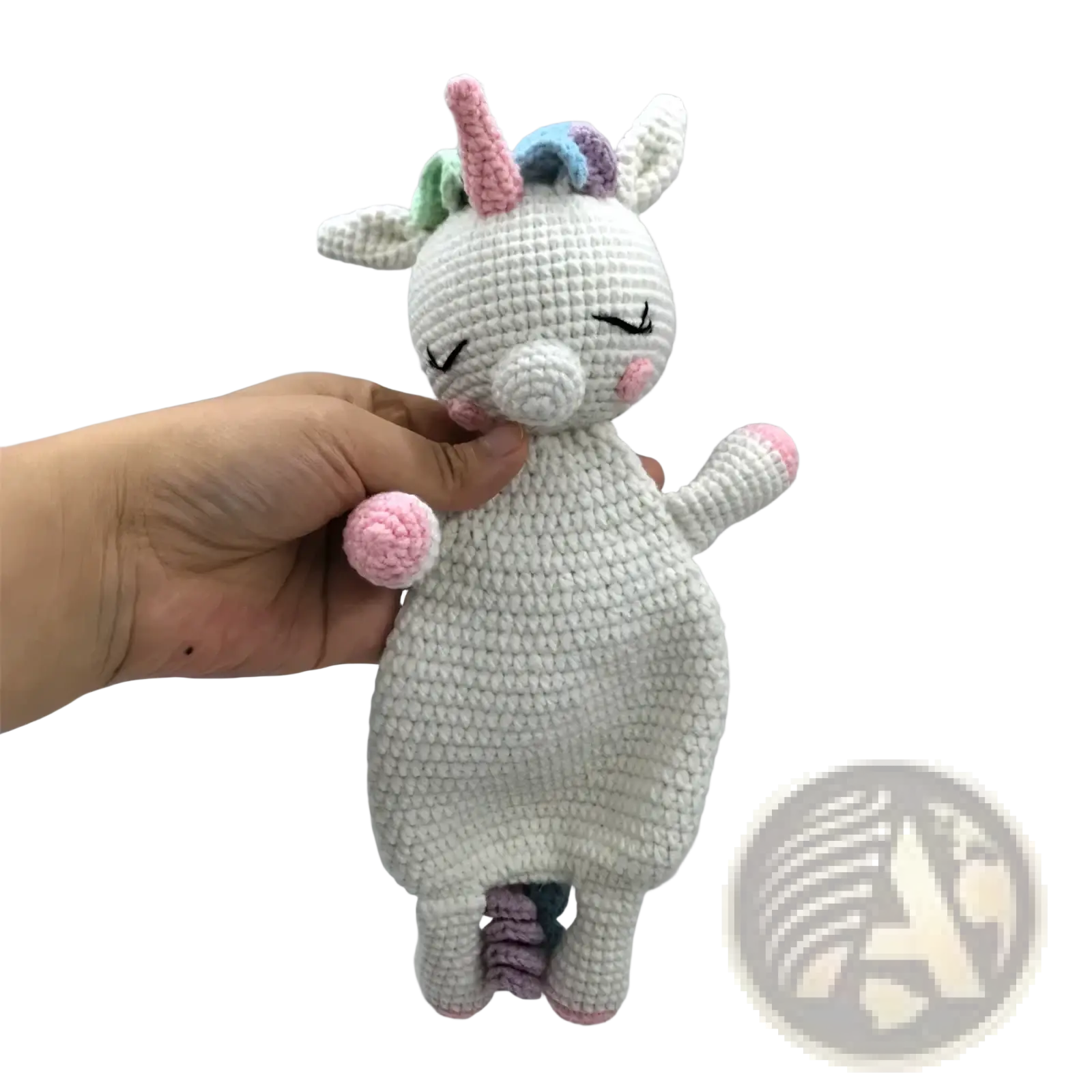 A soft crocheted unicorn baby comforter security blanket with white body pink hooves nose and pastel rainbow horn