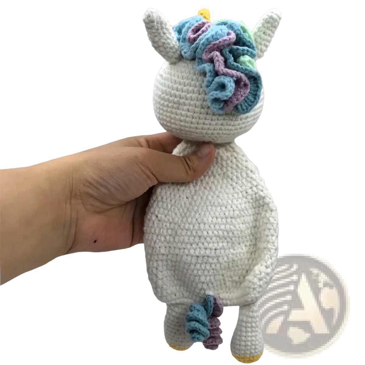 A soft white crocheted unicorn baby comforter with colorful blue and purple yarn mane yellow horn and hooves