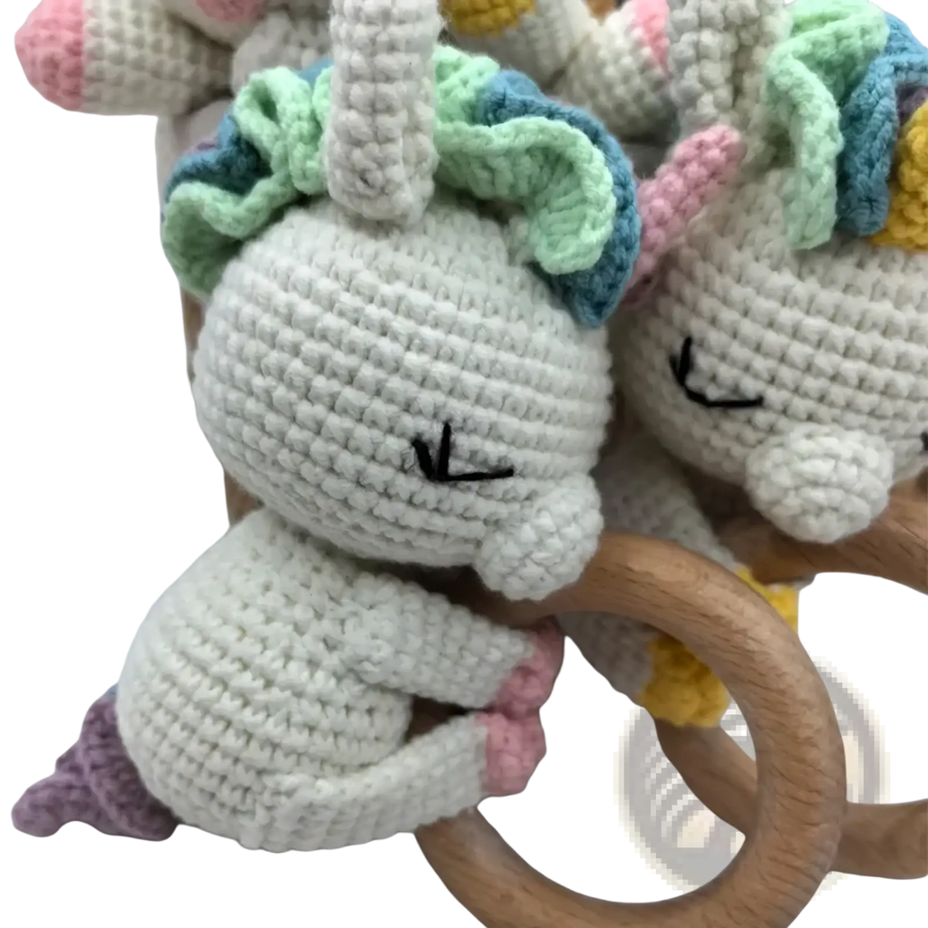 Crocheted unicorn baby comforter security blanket with soft white yarn pastel green and blue mane pink hooves wooden ring handle