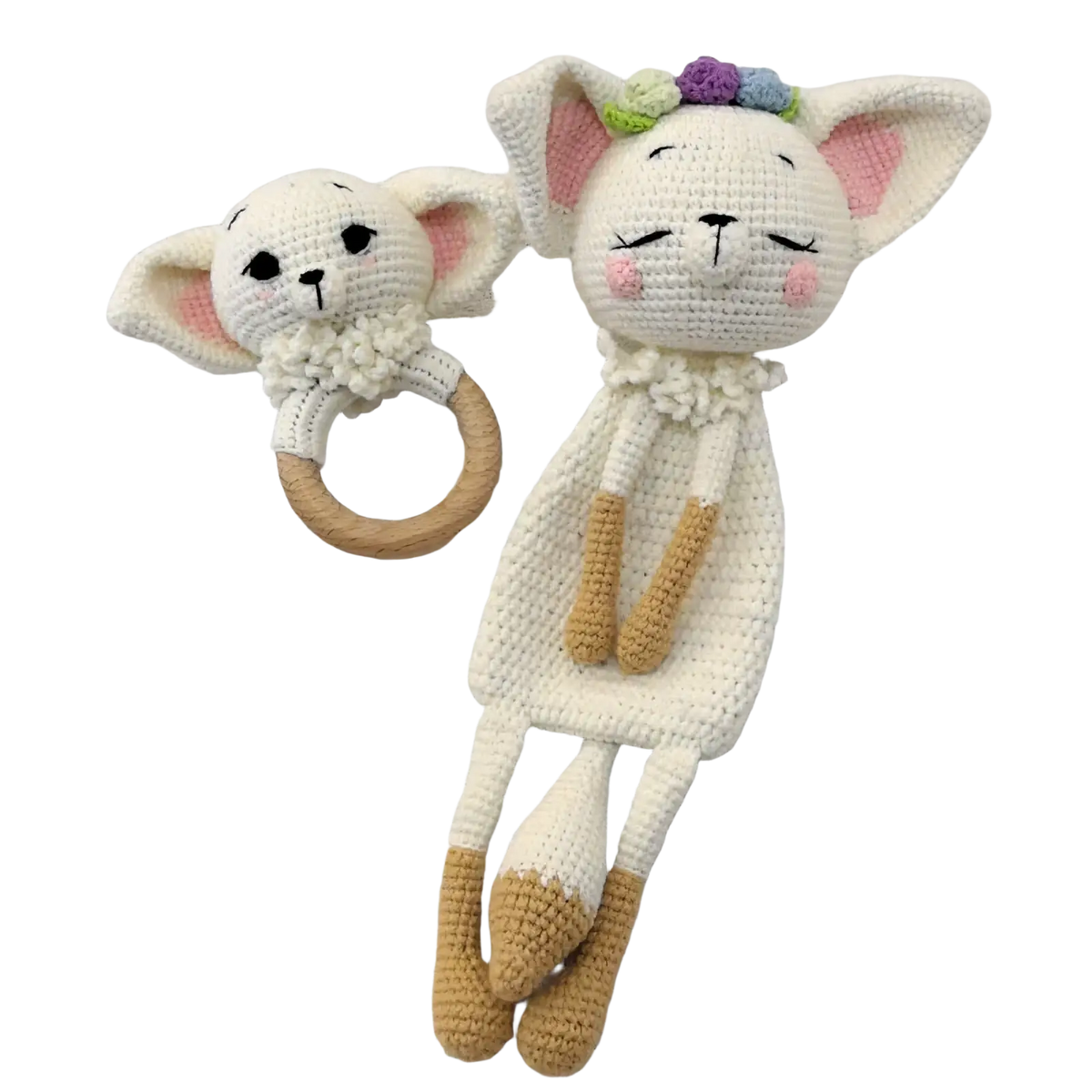 A white crocheted cat rattle with pink ears and floral crown paired with a crocheted unicorn baby comforter blanket
