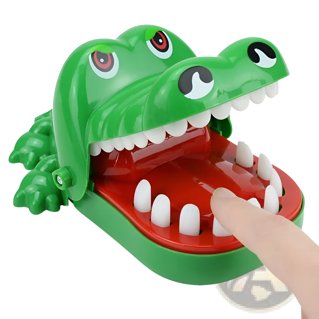 Green plastic crocodile biting finger game toy with hinged jaw red interior white teeth and cartoon eyes for kids