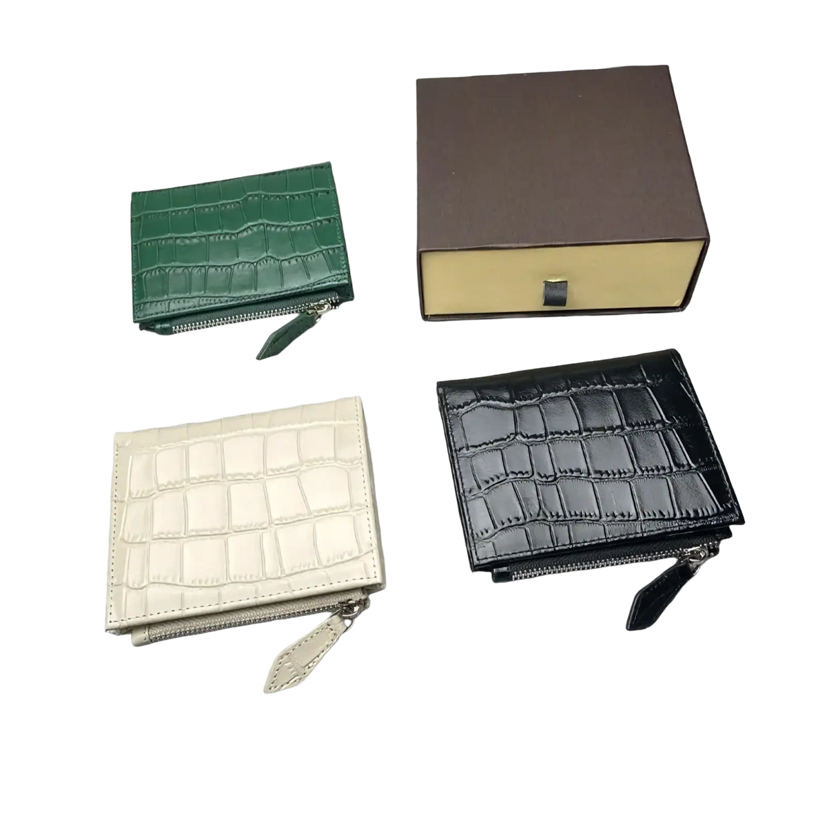 Three compact unisex crocodile leather wallets in green cream and black with zipper closures